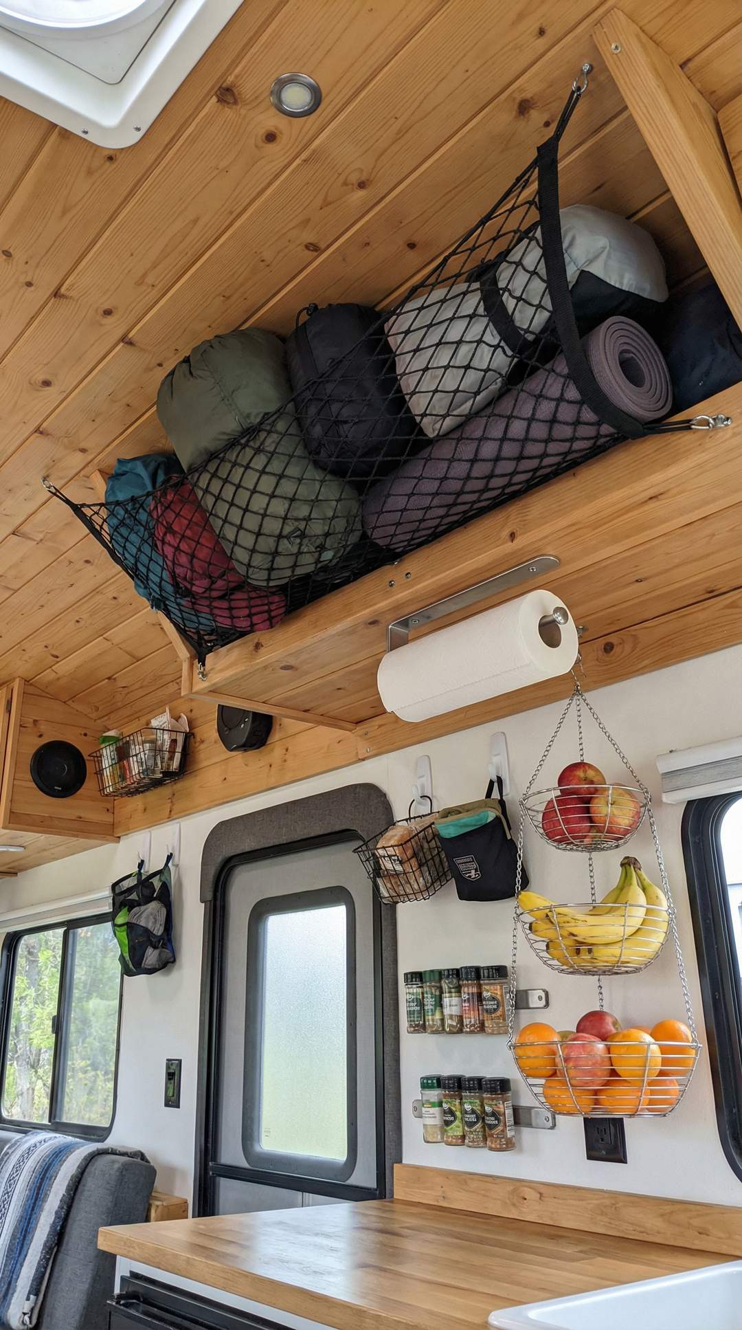 Overhead ceiling storage with cargo nets in RV kitchen