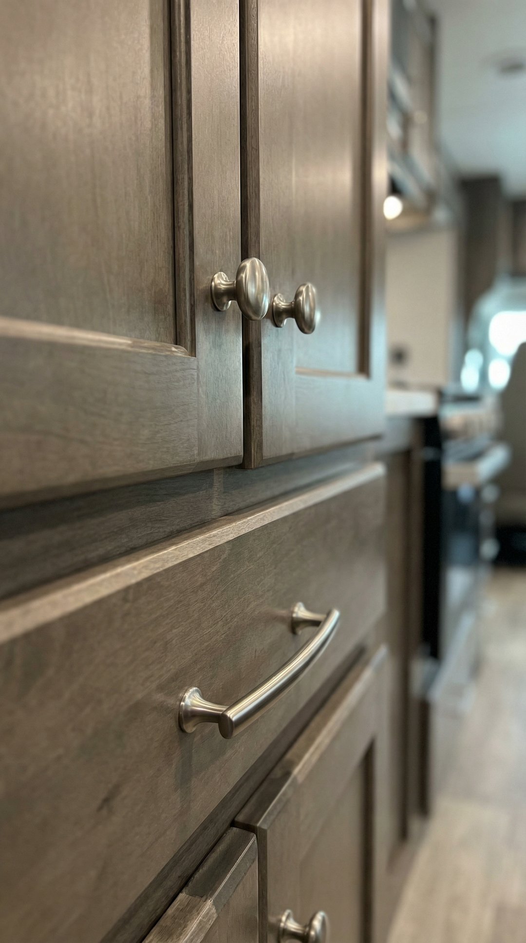 Close-up of modern brushed nickel cabinet hardware on RV cabinets